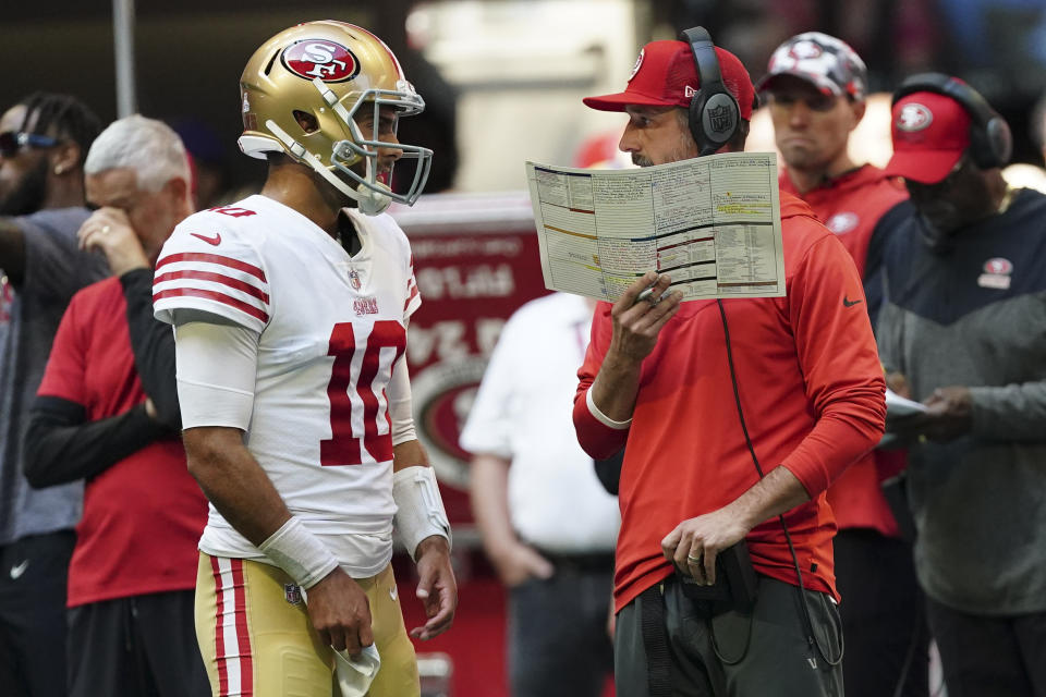 San Francisco 49ers head coach Kyle Shanahan speaks with San Francisco 49ers quarterback Jimmy Garoppolo (10) during the first half of an NFL football game, Sunday, Oct. 16, 2022, in Atlanta. (AP Photo/John Bazemore)