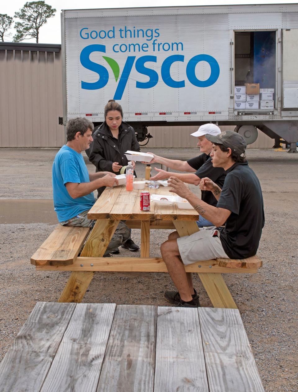 Gulf Coast Seafood's Nina Patti serves her customers lunch from the company's new food trailer on Thursday, Feb. 9, 2023. Gulf Coast Seafood has again begun serving food from a new food truck this week, nearly four months after a fire severely damaged the business late last year.