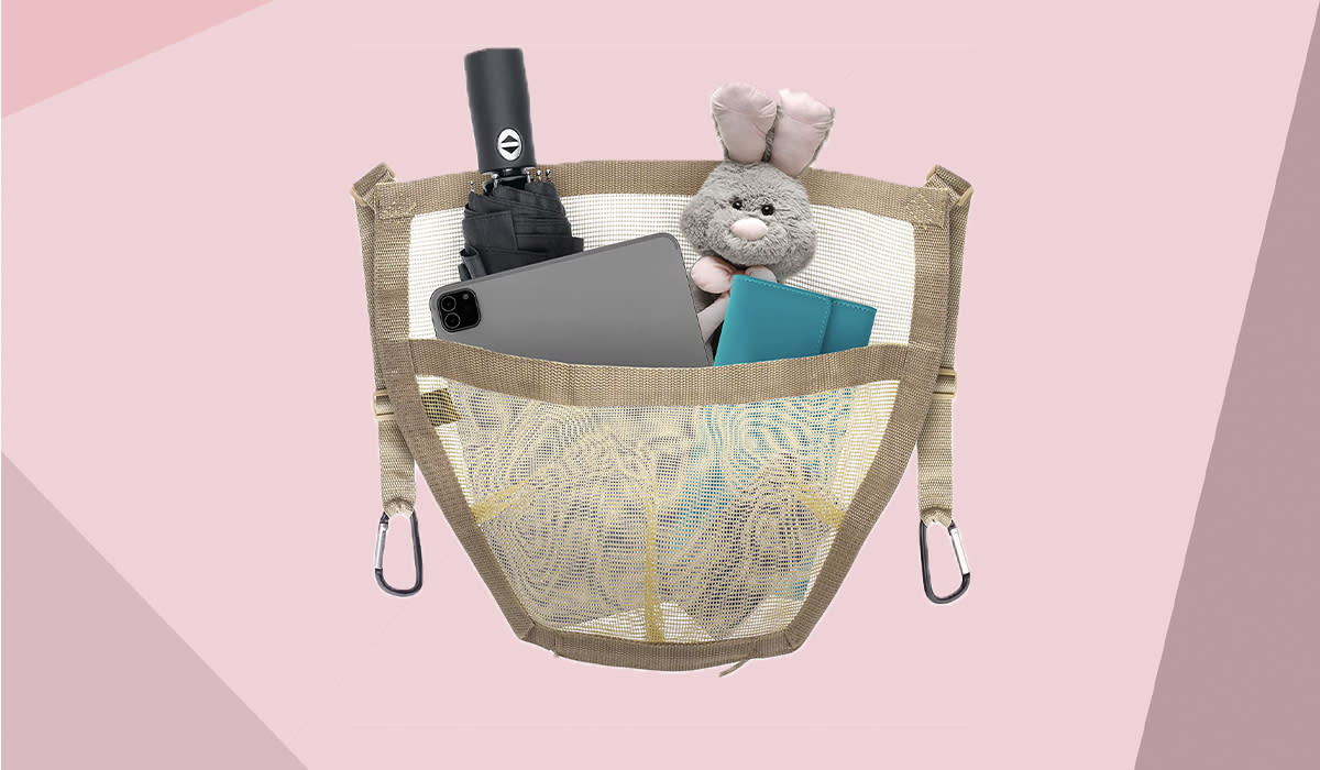 A mesh pouch contains an umbrella, a Kindle, wallet and stuffed rabbit.