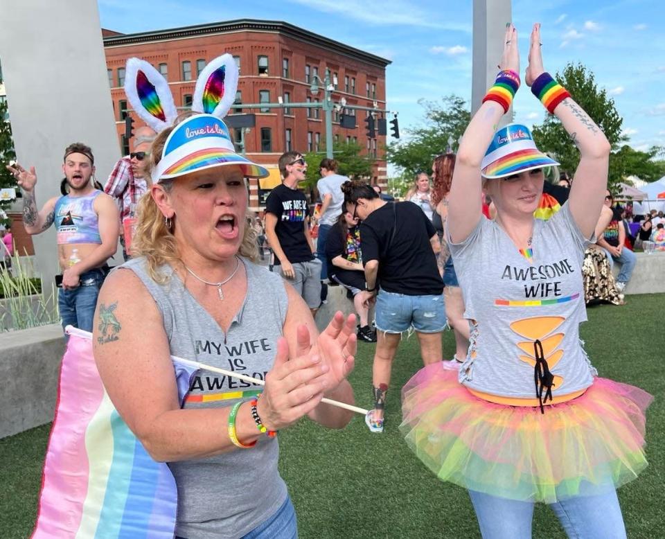 Lynda Whitt, left, and her wife, Chrissie Whitt, of Massillon, applaud the entertainment on Saturday following a group dance at the inaugural Stark Pride Festival in downtown Canton.
