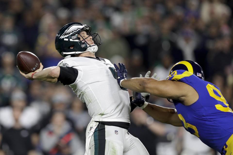 Philadelphia Eagles quarterback Nick Foles, left, passes under pressure from Los Angeles Rams nose tackle Ndamukong Suh during the second half in an NFL football game Sunday, Dec. 16, 2018, in Los Angeles. (AP Photo/Marcio Jose Sanchez)