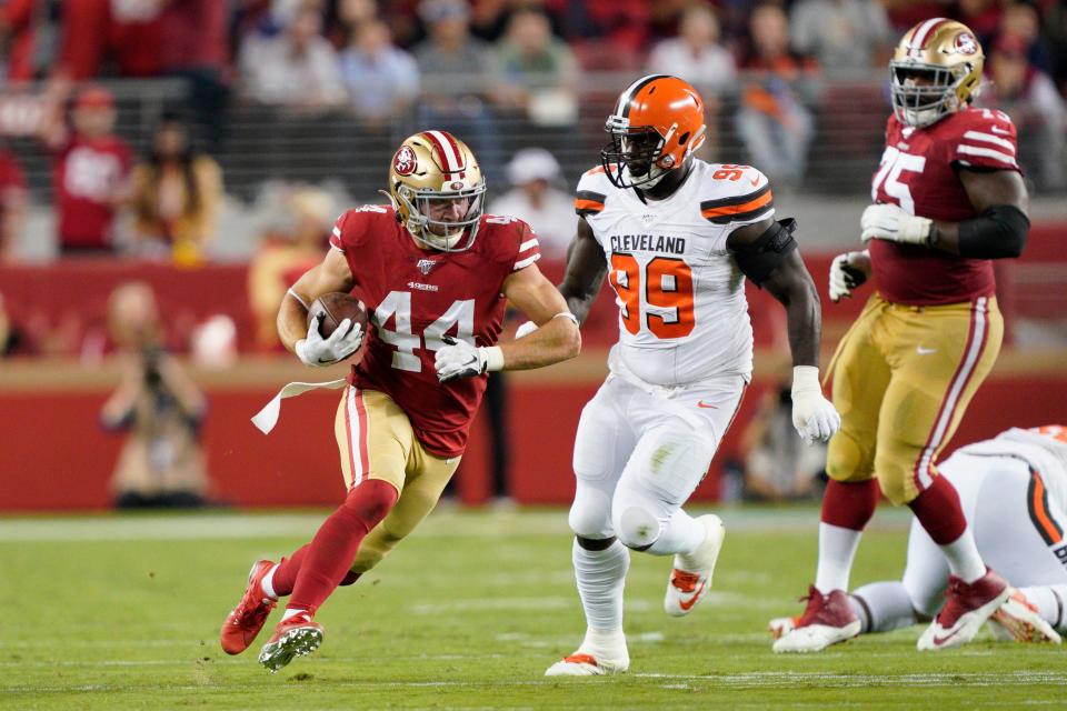 San Francisco 49ers fullback Kyle Juszczyk (44) runs in front of Browns defensive tackle Devaroe Lawrence (99) in Santa Clara, Calif. on Oct. 7, 2019.