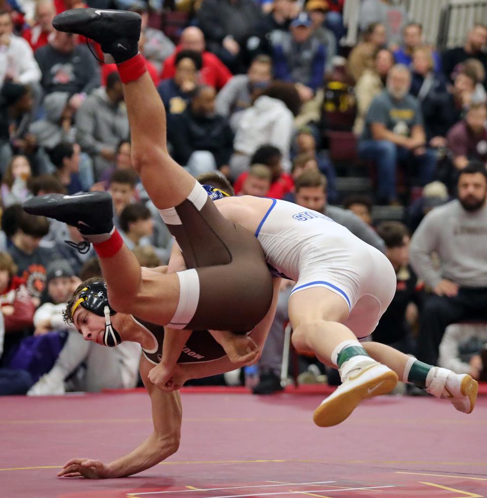 Cael Hughes of Stillwater, right, takes down Sergio Lemley of Mt. Carmel during their 132 pound championship match in the Ironman wrestling tournament at Walsh Jesuit High School, Saturday, Dec. 10, 2022, in Cuyahoga Falls, Ohio.