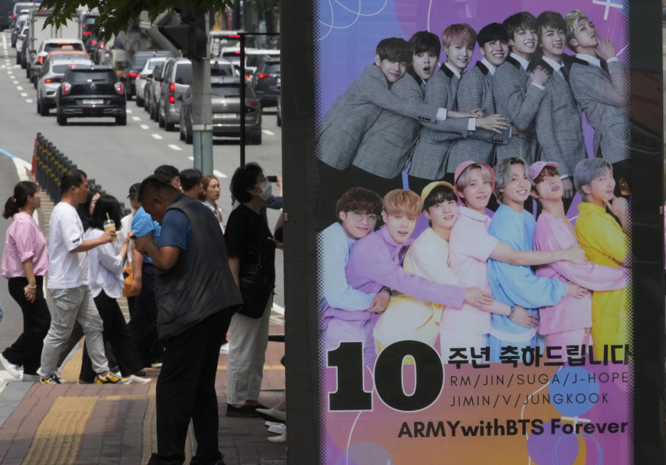 FILE - A poster showing K-pop band BTS members is displayed to celebrate its 10th debut anniversary at a bus station in Seoul, South Korea on June 14, 2023. Four more members of the K-pop supergroup BTS are to begin their mandatory South Korean military duties soon, their management agency said. (AP Photo/Ahn Young-joon, File)