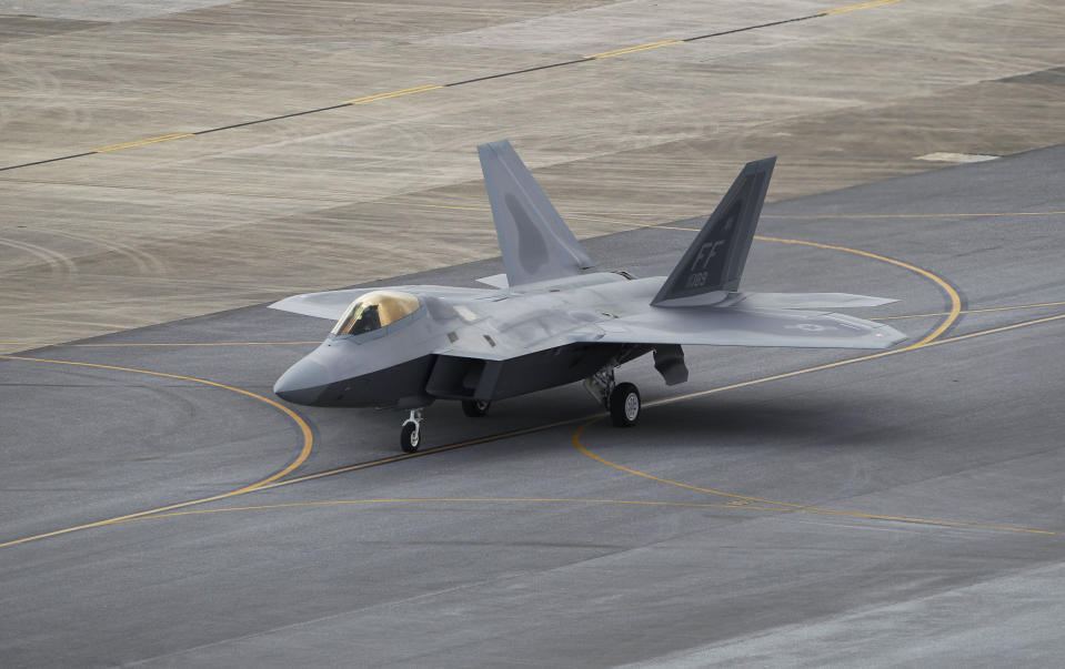 In this Aug. 14, 2012 photo, a U.S. Air Force F-22 Raptor stealth fighter taxis before take-off at Kadena Air Base on the southern island of Okinawa in Japan. The U.S. is hoping a dozen F-22 stealth fighters now roaring through the skies of southern Japan will prove its most prized combat aircraft is finally ready to resume full operations after years of investigations into why its pilots were getting dizzy and disoriented. But questions remain over whether the Air Force has taken enough action to fix a potentially bigger problem - the shriveling of programs to test cockpit life support systems after nearly 20 years of budget cuts, downsizing and outsourcing. (AP Photo/Greg Baker)