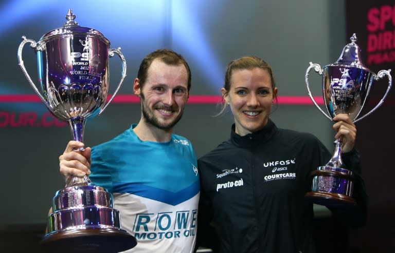 Laura Massaro (R) of Great Britian and Gregory Gaultier of France pose with their trophies after winning the final matches of the World Series finals squash tournament in Dubai, May 28, 2016