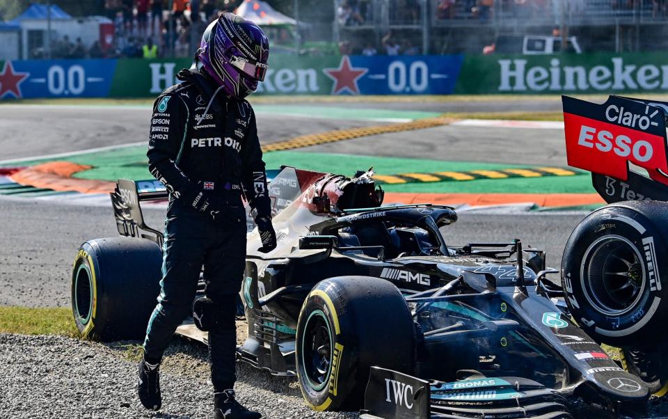 Mercedes' British driver Lewis Hamilton gets out of his car following a collision with Red Bull's Dutch driver Max Verstappen (unseen) during the Italian Formula One Grand Prix at the Autodromo Nazionale circuit in Monza, on September 12, 2021. - AFP