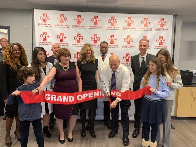 Joe Castelano is at rear left as Cedar Grove Mayor Joseph Cicala cuts the ribbon at the grand opening of an American Family Care center in Cedar Grove in 2018.