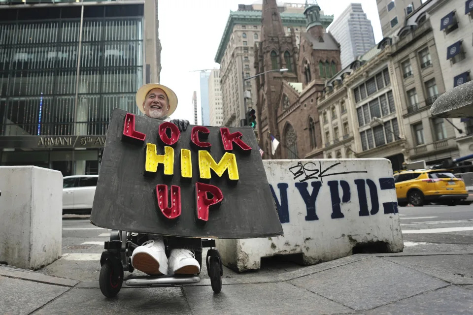 Richard Fisher protests former President Donald Trump outside Trump Tower on Friday, March 31, 2023, in New York. Former President Donald Trump was indicted by a Manhattan grand jury, Thursday, a historic reckoning after years of investigations into his personal, political and business dealings and an abrupt jolt to his bid to retake the White House.(AP Photo/Bryan Woolston)