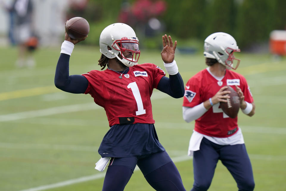 New England Patriots quarterbacks Cam Newton (1) and Jarrett Stidham (4) wind up to pass during an NFL football minicamp practice, Tuesday, June 15, 2021, in Foxborough, Mass. (AP Photo/Steven Senne)