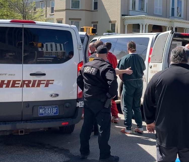 Erie County sheriff's deputies and other law enforcement officials help transfer Erie County Prison inmates from a sheriff's transport van, at right, to another van after the transport van was involved in an accident at West Ninth and Sassafras streets in Erie at about 11:20 a.m. on Thursday. Twelve inmates were on the van. Five were taken to the hospital, officials said.