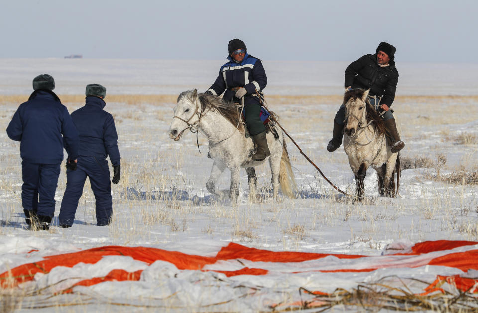 Kazakh shepherds ride near a parachute close to the place where Russian Soyuz MS-13 space capsule landed about 150 km (90 miles) south-east of the Kazakh town of Zhezkazgan, Kazakhstan, Thursday, Feb. 6, 2020. A Soyuz space capsule with U.S. astronaut Christina Koch, Italian astronaut Luca Parmitano and Russian cosmonaut Alexander Skvortsov, returning from a mission to the International Space Station landed safely on Thursday on the steppes of Kazakhstan. (Sergei Ilnitsky/Pool Photo via AP)