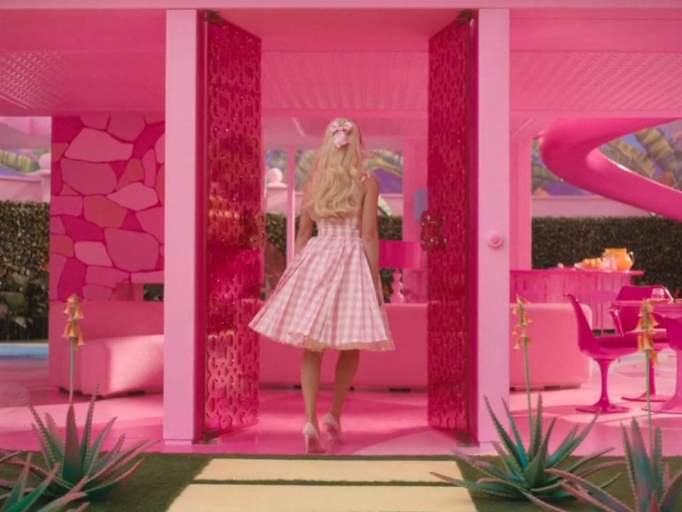 barbie walks into her dreamhouse in the movie. it's bright pink and has no exterior walls