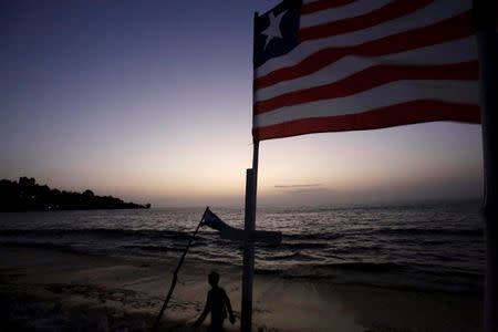 FILE PHOTO: A boy walks on the beach in the township of West Point, in Monrovia, Liberia, October 18, 2017. REUTERS/Thierry Gouegnon/File Photo