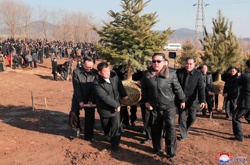 FILE PHOTO: North Korean leader Kim Jong Un takes part in an event to plant trees with the participants of the 2nd Conference of Secretaries of Primary Committees of the Workers' Party of Korea