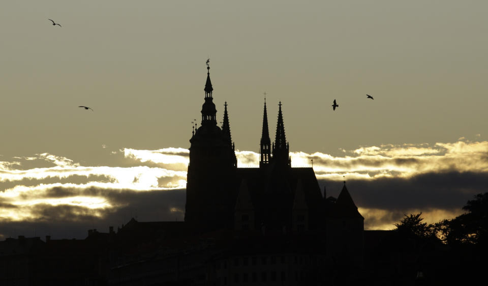 In this file picture taken on Oct. 13, 2009, the sun sets behind the St. Vitus cathedral in Prague, Czech Republic. On Wednesday Jan. 23, 2019, the lower house of Czech Parliament has approved a proposal drafted by the Communist Party to tax the compensation that the country's churches receive for property seized by the former Communist regime. (AP Photo/Petr David Josek, File)