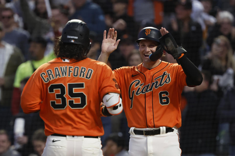 San Francisco Giants' Casey Schmitt, right, congratulates Brandon Crawford, who hit a two-run home run against the Colorado Rockies duirng the sixth inning of a baseball game in San Francisco, Friday, July 7, 2023. (AP Photo/Josie Lepe)