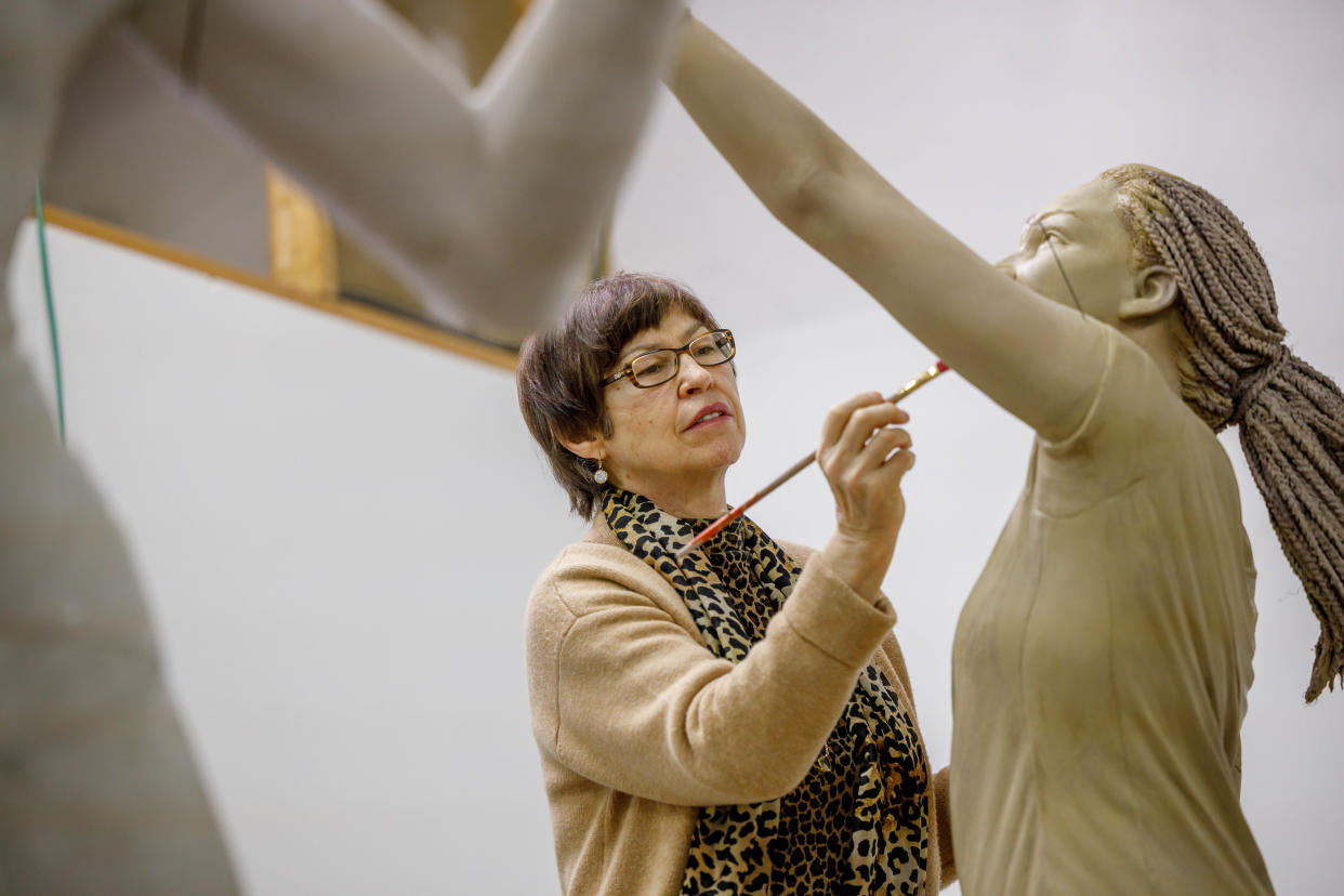 Indiana University South Bend art professor Dora Natella works on one of the figures for "The Spirit of Indiana."