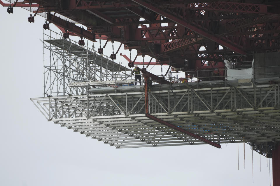 A suicide deterrent net is seen under construction beneath the Golden Gate Bridge in San Francisco, Wednesday, Dec. 6, 2023. The barrier at the bridge is near completion more than a decade after officials approved it. (AP Photo/Eric Risberg)