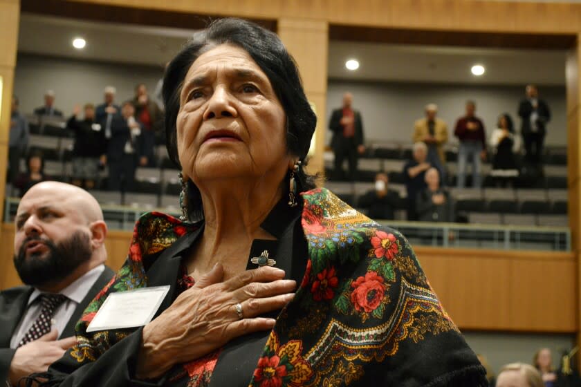 FILE - In this Feb. 27, 2019, file photo, Dolores Huerta, the Mexican-American social activist who formed a farmworkers union with Cesar Chavez, stands for the Pledge of Allegiance in Spanish while visiting the New Mexico Statehouse in Santa Fe. N.M. Huerta is endorsing Joe Biden, giving him the backing of one of the nation's most prominent Latino leaders. (AP Photo/Russell Contreras, File)