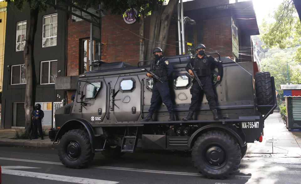 A police vehicle arrives to the place where an abandoned vehicle that is believed to have been used by gunmen in an attack against the chief of police was found, in Mexico City, Friday, June 26, 2020. Heavily armed gunmen attacked and wounded Omar Garcia Harfuch in a brazen operation that left an unspecified number of dead, Mayor Claudia Sheinbaum said Friday. (AP Photo/Marco Ugarte)