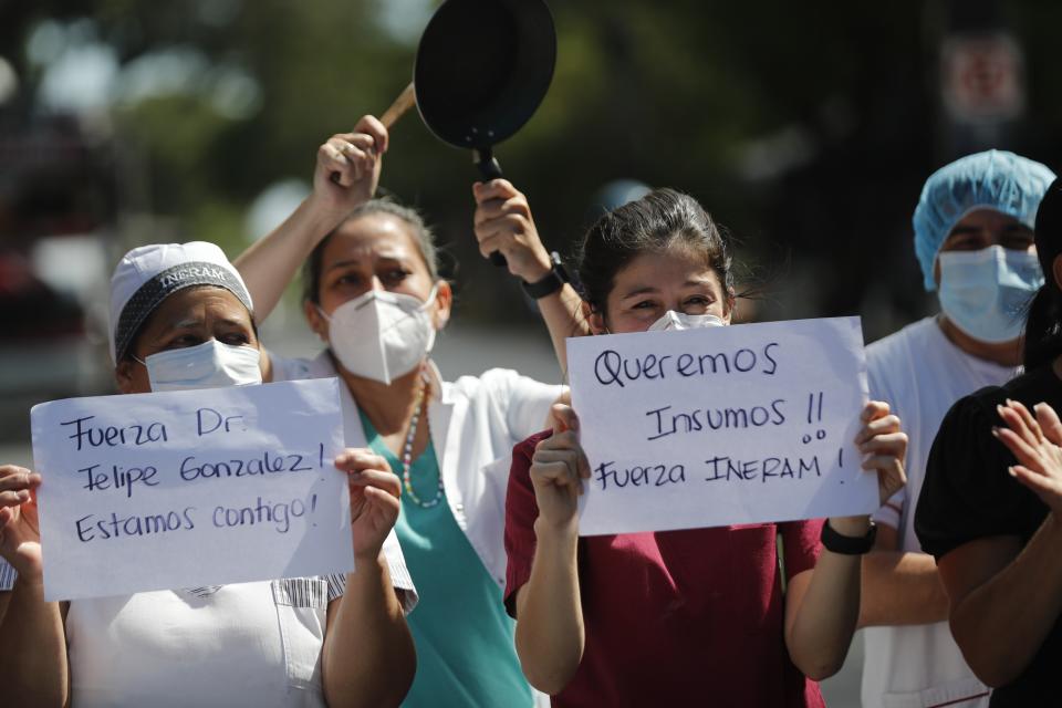 Respiratory Hospital INERAM health workers bang pots and carry the Spanish messages "We want supplies! Be strong INERAM!," right, and "Be strong Dr. Felipe Gonzalez! We're with you!," during a protest demanding more materials for the ICU in Asuncion, Paraguay, Wednesday, March 3, 2021, the day after INERAM Director Felipe Gonzalez resigned. Without vaccines or basic drugs to combat COVID-19, Paraguay's main public hospitals became unable to receive patients in intensive care units on Wednesday. (AP Photo/Jorge Saenz)