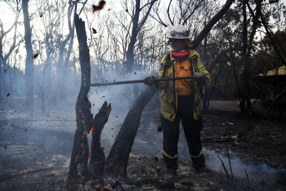 A NSW RFS firefighter undertakes mopping up at South Turramurra.