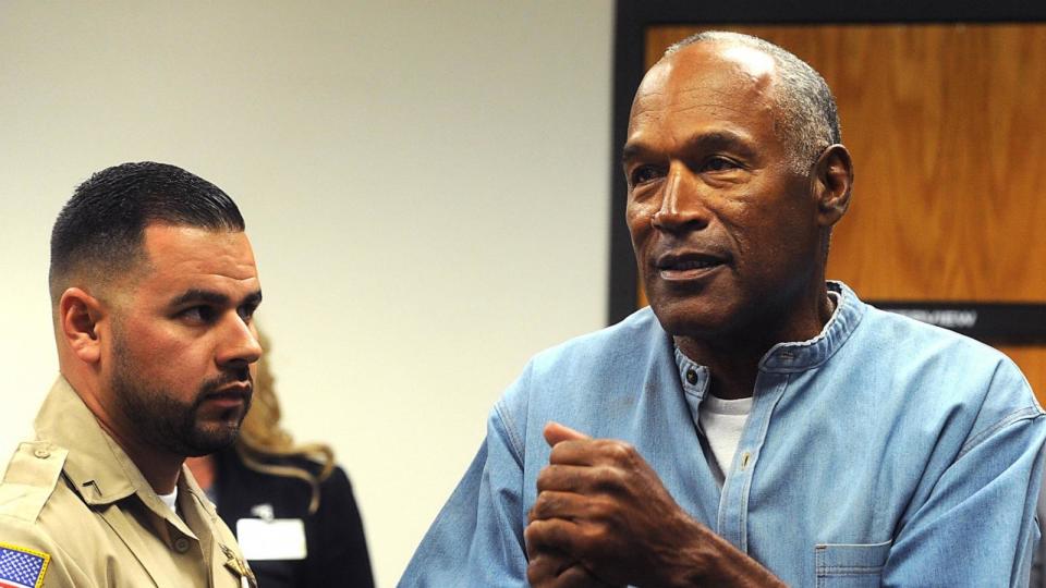 PHOTO: O.J. Simpson (C) reacts after learning he was granted parole at Lovelock Correctional Center July 20, 2017 in Lovelock, Nev. (Jason Bean-Pool/Getty Images, FILE)