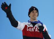 Silver medalist Denny Morrison of Canada jumps during the medal ceremony for the men's 1,000 metres short track speed skating event at the 2014 Sochi Winter Olympics February 13, 2014. REUTERS/Eric Gaillard (RUSSIA - Tags: OLYMPICS SPORT SPEED SKATING)