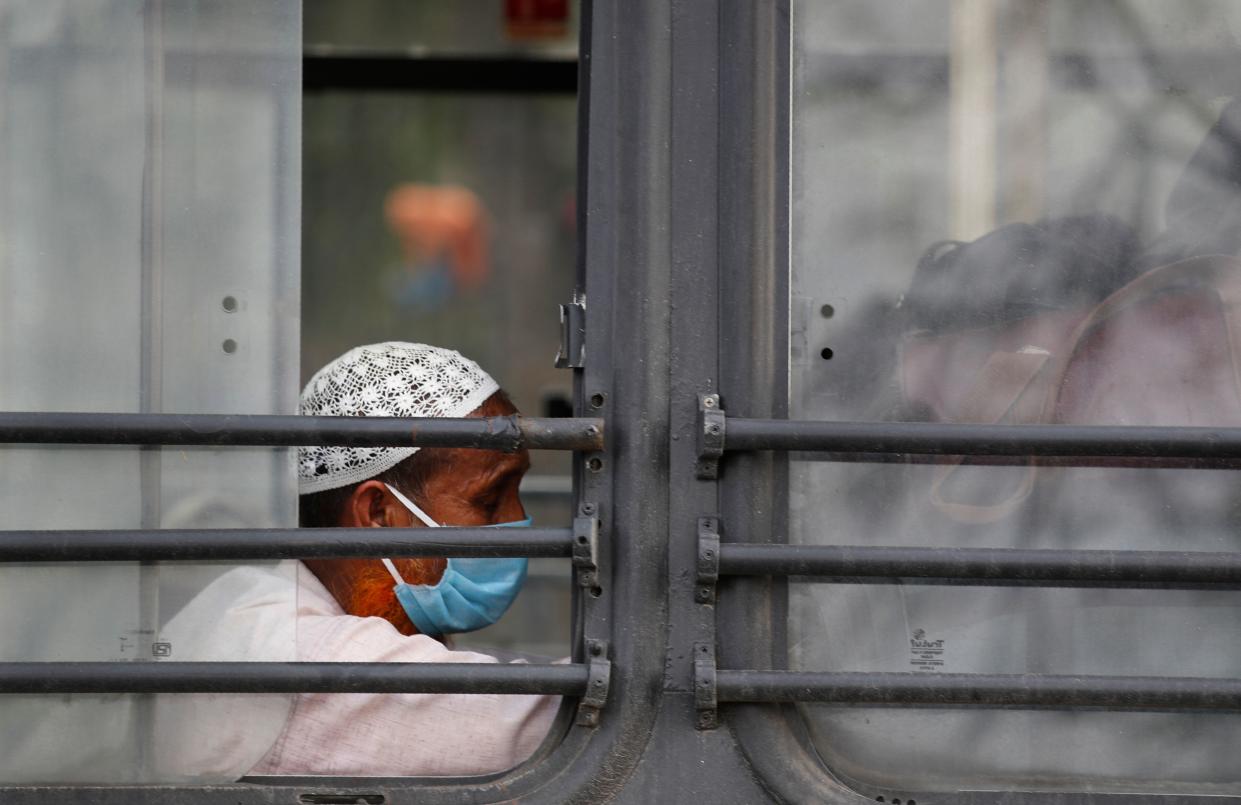 Muslim pilgrims wait in a bus that will take them to a quarantine facility, amid concerns over the spread of the coronavirus in Nizamuddin, New Delhi, on March 31, 2020.  (ASSOCIATED PRESS)