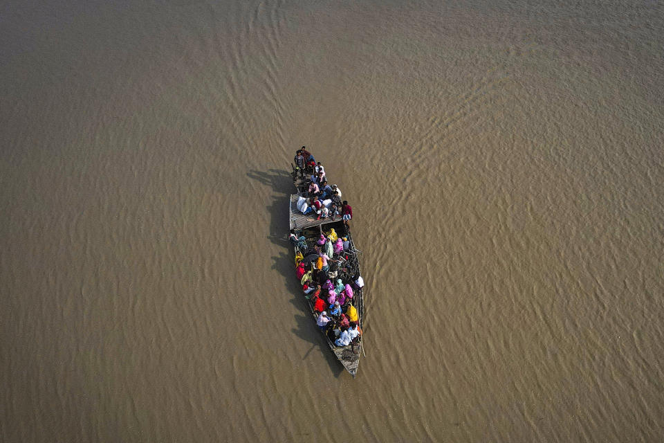 People cross the Brahmaputra river in a boat to reach a polling booth during the second round of voting in the six-week-long national election in Morigaon district, Assam, India, Friday, April 26, 2024. (AP Photo/Anupam Nath)