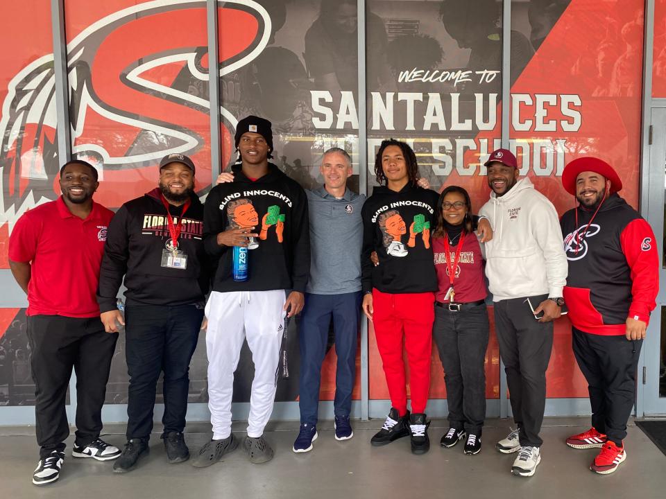 Florida State football coach Mike Norvell (center) stands with 2025 recruits Jamar Browder and Caden Gordon, along with Santaluces High staff.