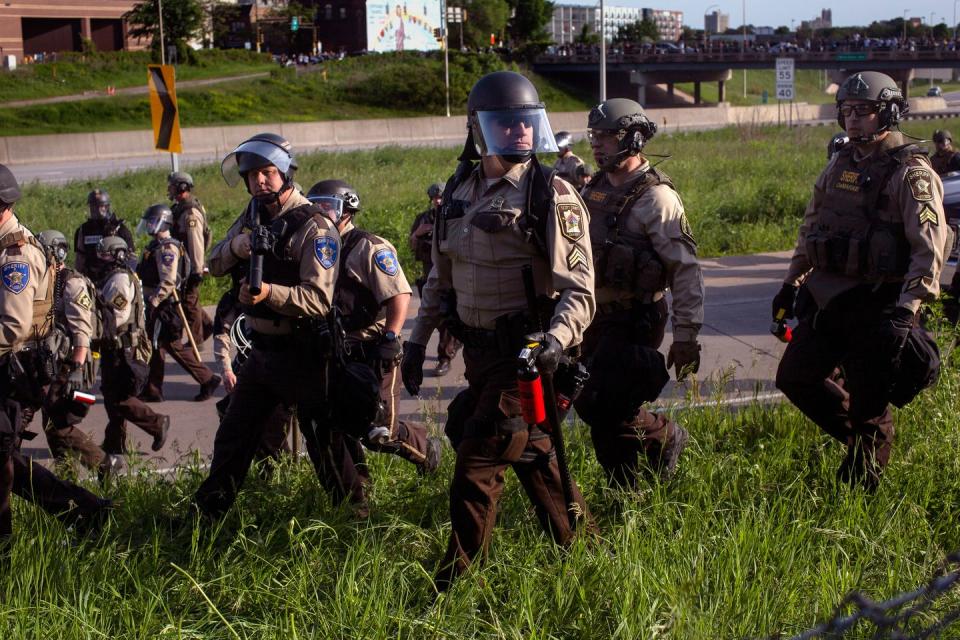 <p>Police descend on protesters who closed down a freeway in Minneapolis on May 31. </p>