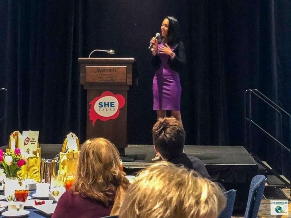 Lakisha Simmons delivering a keynote at a women's conference.