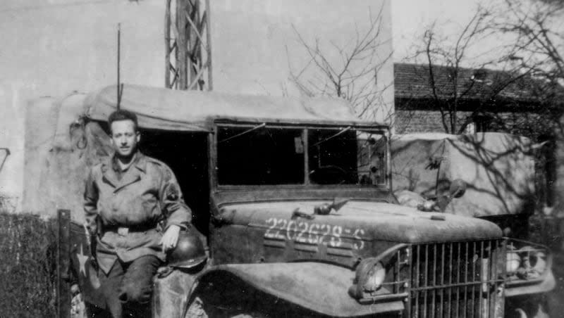 Staff Sgt. Stanley Nance, who served in the once-secret 23rd Headquarters Special Troops, a unit also known as the Ghost Army, stands alongside his radio vehicle, which he named the "Kilowatt Kommand," circa 1945.