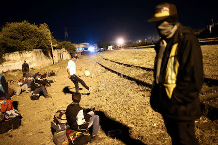 A Central American migrant, moving in a caravan through Mexico, plays with a ball next to a railway line before embarking on a new leg of his travels, in Tlaquepaque, in Jalisco state, Mexico April 18, 2018. Picture taken April 18, 2018. REUTERS/Edgard Garrido