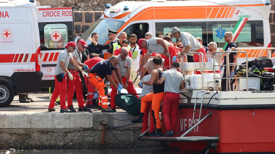 Emergency services carry a body bag