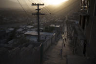 Afghans walk in an alleyway as the sun sets in Kabul, Afghanistan, Thursday, Sept. 16, 2021. (AP Photo/Felipe Dana)