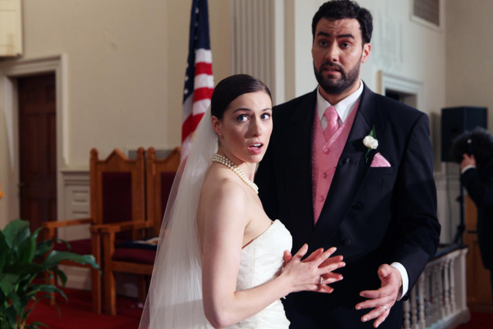 Alison Fyhrie, Philip Quinaz dressed as a bride and groom both having shocked looks on their faces in a courthouse setting