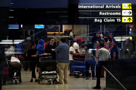 International passengers arrive at Washington Dulles International Airport after clearing immigration and customs in Dulles, Virginia, U.S. September 24, 2017. REUTERS/James Lawler Duggan