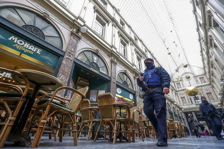 A Belgian police patrols in central Brussels as investigators search the area during a continued high level of security following the recent deadly Paris attacks, Belgium, November 24, 2015. REUTERS/Yves Herman