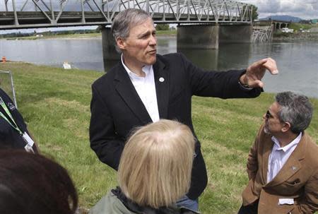 Washington State Governor Jay Inslee looks over the scene as a span of highway bridge sits in the Skagit River May 24, 2013 after collapsing near the town of Mt Vernon, Washington late Thursday. REUTERS/Cliff DesPeaux