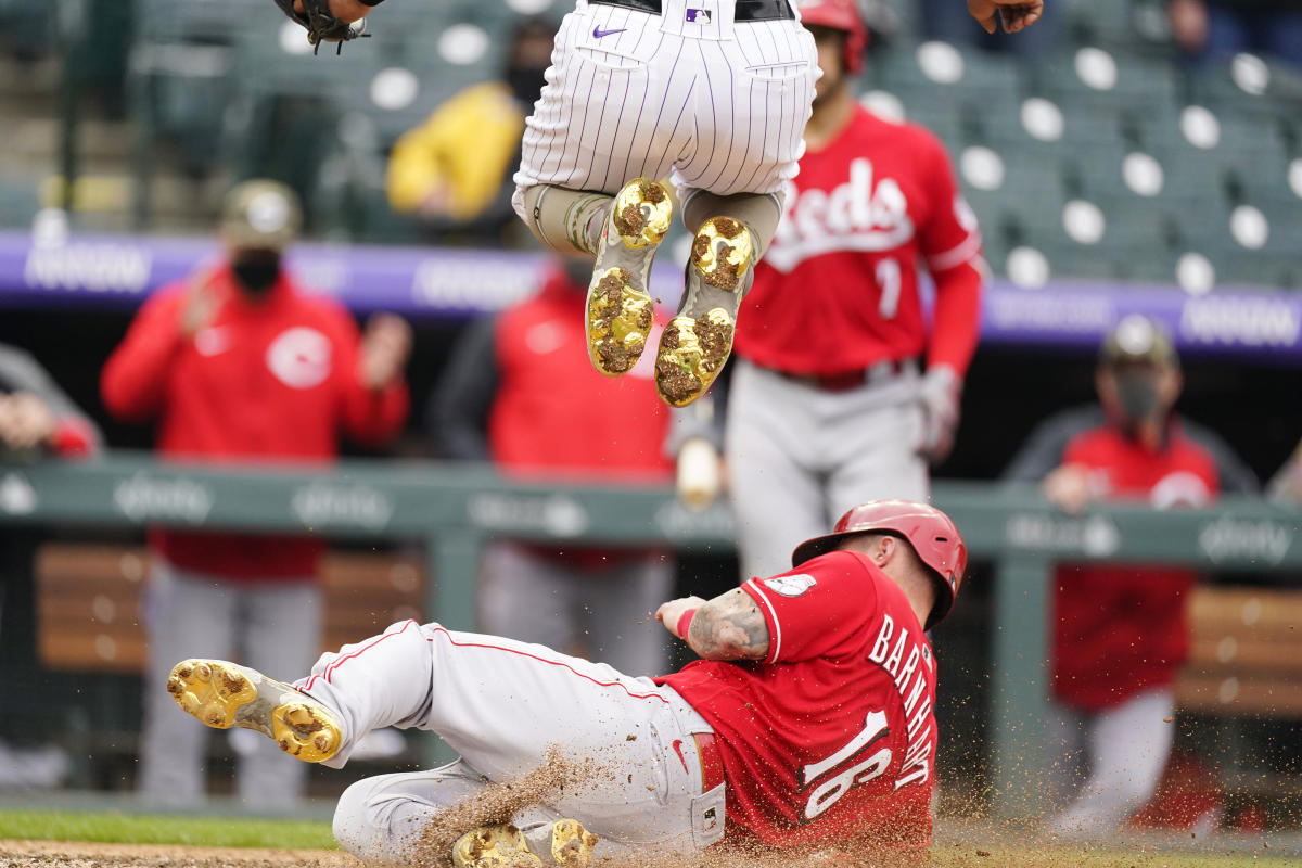 Eugenio Suarez of the Cincinnati Reds reacts after sliding past