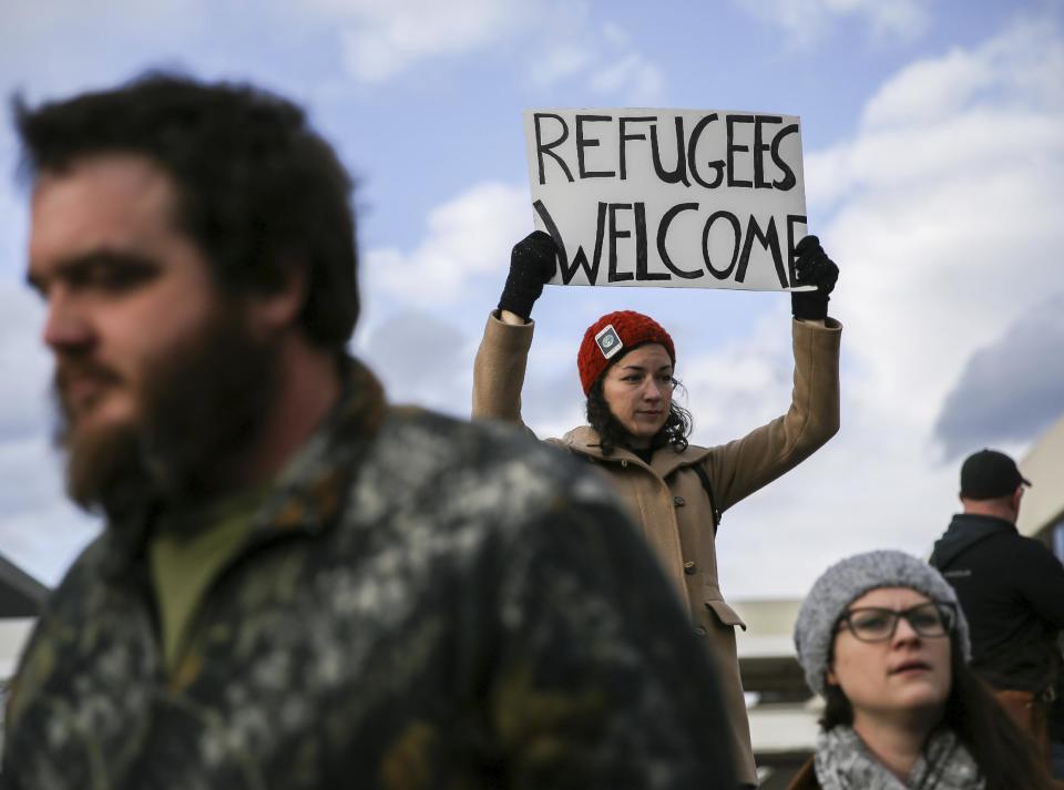 A demonstrator holds a sign at Hartsfield-Jackson International Airport during a demonstration to denounce President Donald Trump's executive order that bars citizens of seven predominantly Muslim-majority countries from entering the U.S., Sunday, Jan. 29, 2017, in Atlanta. (AP Photo/Branden Camp)