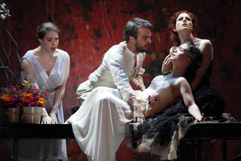 In this May 10, 2012 photo provided by the New York City Opera, from left, Meredith Lustig is in the role of Cephisa with Daniel Teadt in the title role, Joélle Harvey as Eurydice and Catherine Miller as Thanatos during a dress rehearsal of the New York City Opera's "Orpheus," at El Museo del Barrio in New York. (AP Photo/NYC Opera, Carol Rosegg)