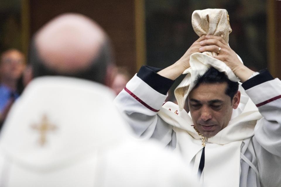 Deacon Wissam Akiki, who is married, is ordained to the priesthood during a ceremony at St. Raymond’s Maronite Cathedral Thursday, Feb. 27, 2014, in St. Louis. Akiki is the first married priest to be ordained by the Maronite Catholic Church in the United States in nearly a century. (AP Photo/Erin Stubblefield)