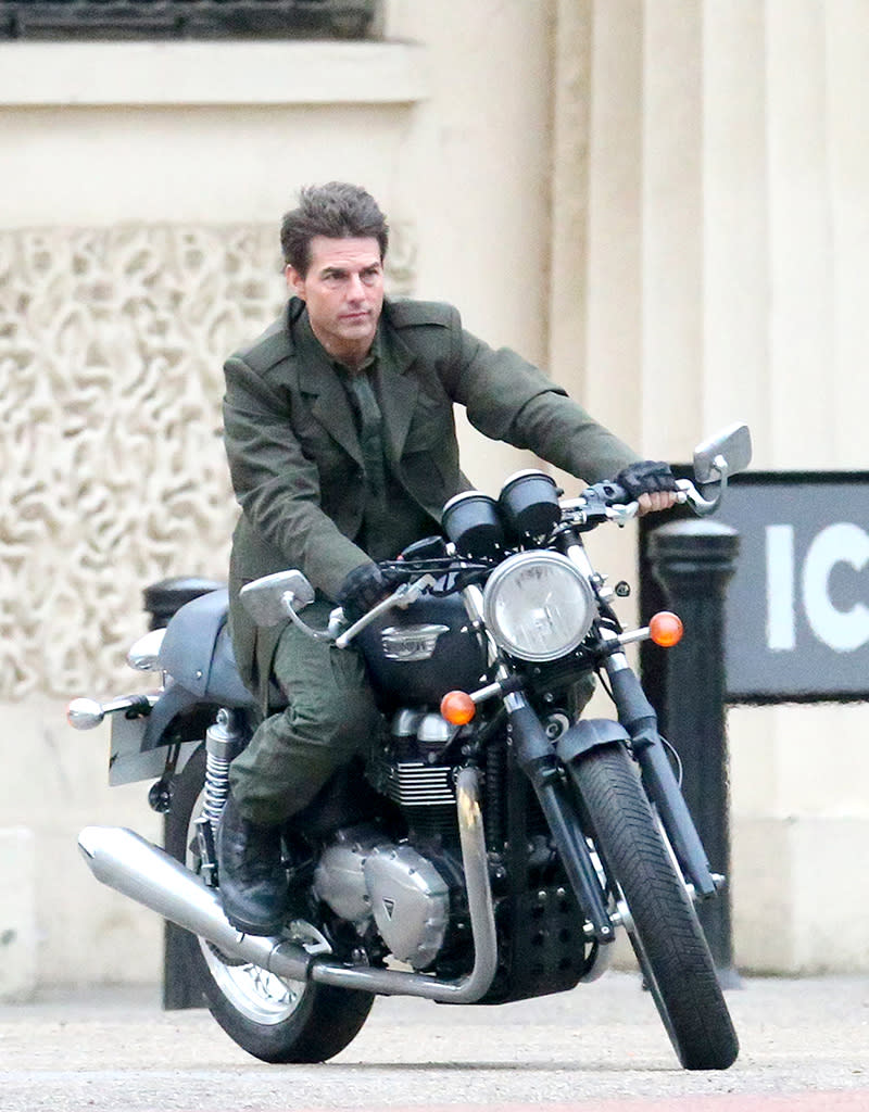 Tom Cruise rides a motorbike down The Mall without a crash helmet, London, UK