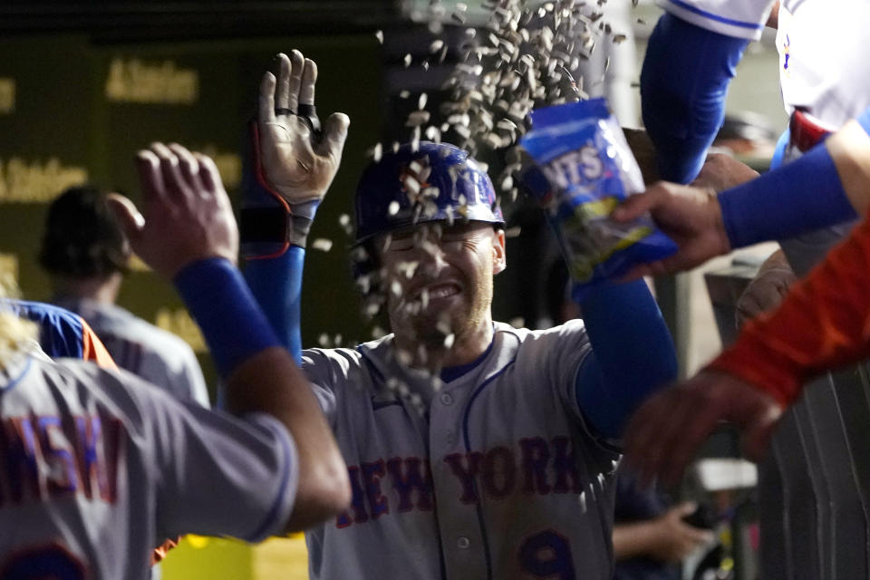 New York Mets' Brandon Nimmo is showered with sunflower seed in the dugout after his home run off Chicago Cubs relief pitcher Mark Leiter Jr., during the sixth inning of a baseball game Thursday, July 14, 2022, in Chicago. (AP Photo/Charles Rex Arbogast)