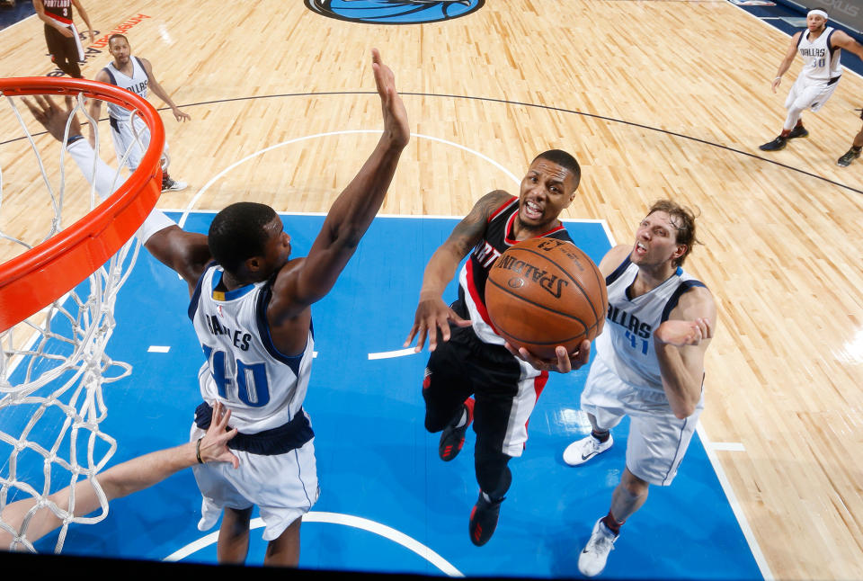 Damian Lillard's Blazers and the Dirk Nowitzki-and-Harrison Barnes-led Mavericks are two of six teams vying for one playoff spot. (Getty Images)