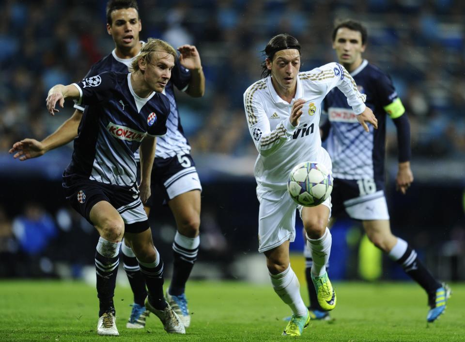 Real Madrid's German midfielder Mesut Ozil (R) vies with Dinamo Zagreb's Dinamo Zagreb's defender Domagoj Vida during the UEFA Champions league first leg football match Real Madrid vs Dinamo Zagreb at the Santiago Bernabeu stadium in Madrid on November 22, 2011. AFP PHOTO/ PIERRE-PHILIPPE MARCOU (Photo credit should read PIERRE-PHILIPPE MARCOU/AFP/Getty Images)